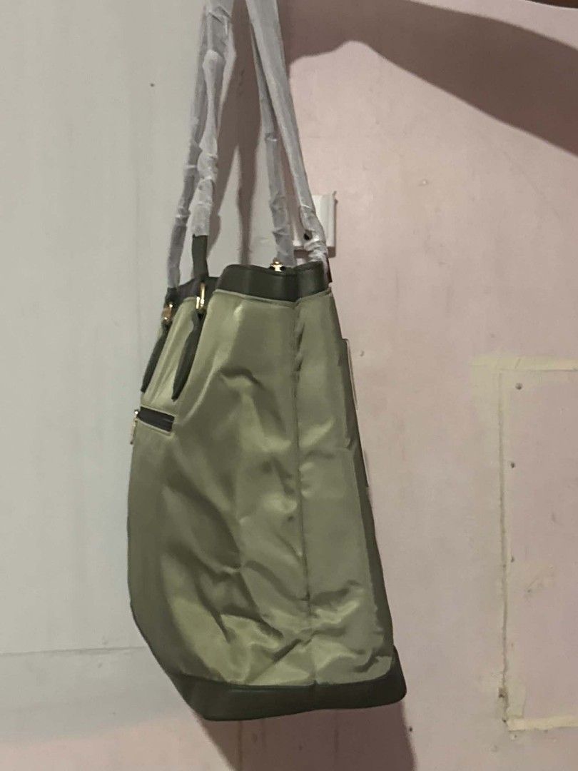 LOVEVOOK Tote Bag (Category: Tote Bags) located in Manila. Submitted by vsballeras1984 (Listing ID 1464066965, Image 2). Description: - LOVEVOOK colorblock tote bag - Stylish olive green and cream panels - Convenient zippered back pocket - Includes a matching pouch - Handles still wrapped in original plastic - Ideal for everyday use.