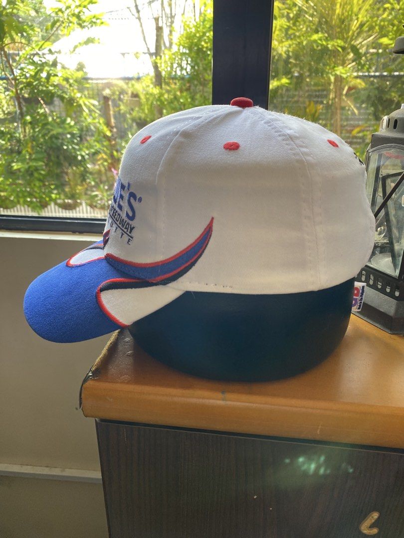 Lowe's Motor Speedway Charlotte Flames Cap (Category: Caps & Hats) located in Iloilo. Submitted by jlpogi27 (Listing ID 1463982943, Image 2). Description: - White cap with blue and red flame accents. - Features the Lowe's Motor Speedway Charlotte logo on the front. - Back of the cap has embroidered eyes and the text 'The Beast of the Southeast'. - Adjustable strap for a comfortable and secure fit. - Ideal for any NASCAR or racing enthusiast..