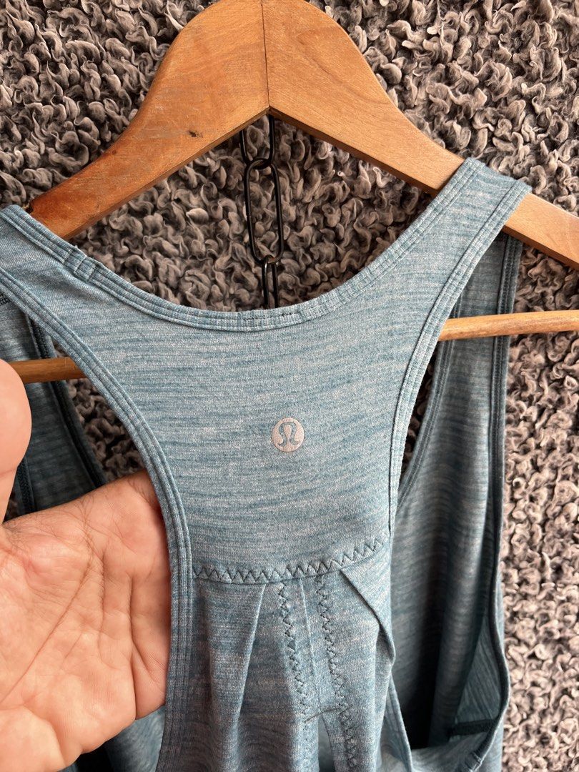 Lululemon Essential Tank | Size 10 (Category: Shirts) located in General Trias. Submitted by zrchustle.604 (Listing ID 1463954332, Image 3). Description: Lululemon Essential Tank in a heathered green/teal shade, most likely Heathered Persian Blue or Heathered Deep Green. It is made from a lightweight, sweat-wicking Seriously Light™ Luon fabric and features a scoop neckline, a loose silhouette with a curved hemline, and distinct pleated detailing 
