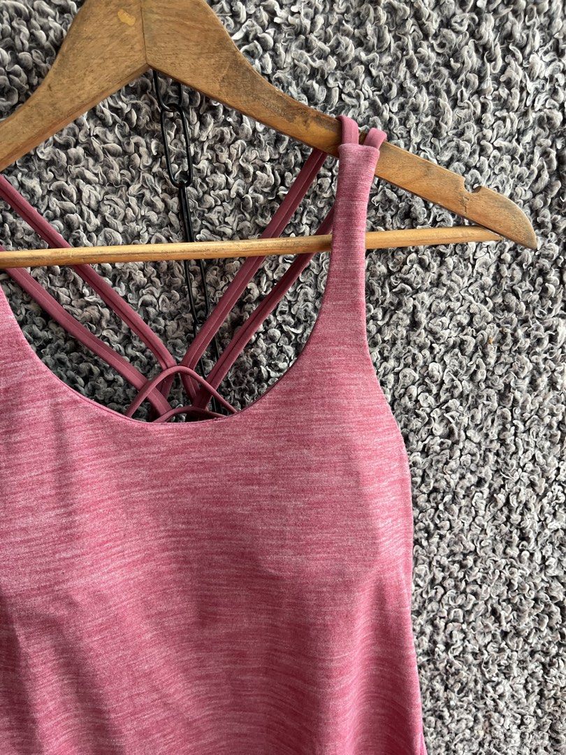 Lululemon Sunset Salutation Tank | Size 4 (Category: Shirts) located in General Trias. Submitted by zrchustle.604 (Listing ID 1463954853, Image 2). Description: Lululemon Sunset Salutation Tank in the heathered cranberry colorway. This athletic piece features a scoop neckline, a flared, flowy lower hem, and a distinctive built-in sports bra with multiple crisscrossing spaghetti straps at the back..