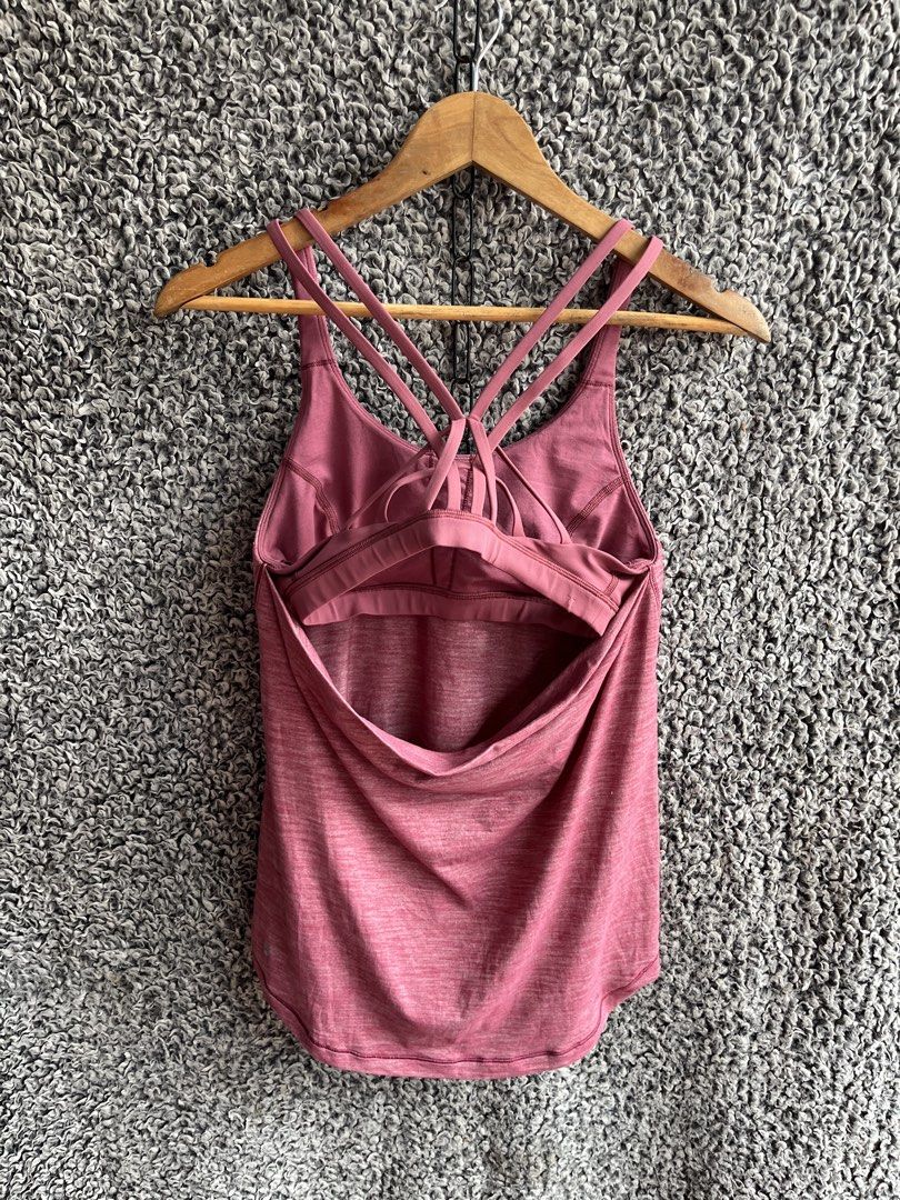 Lululemon Sunset Salutation Tank | Size 4 (Category: Shirts) located in General Trias. Submitted by zrchustle.604 (Listing ID 1463954853, Image 3). Description: Lululemon Sunset Salutation Tank in the heathered cranberry colorway. This athletic piece features a scoop neckline, a flared, flowy lower hem, and a distinctive built-in sports bra with multiple crisscrossing spaghetti straps at the back..