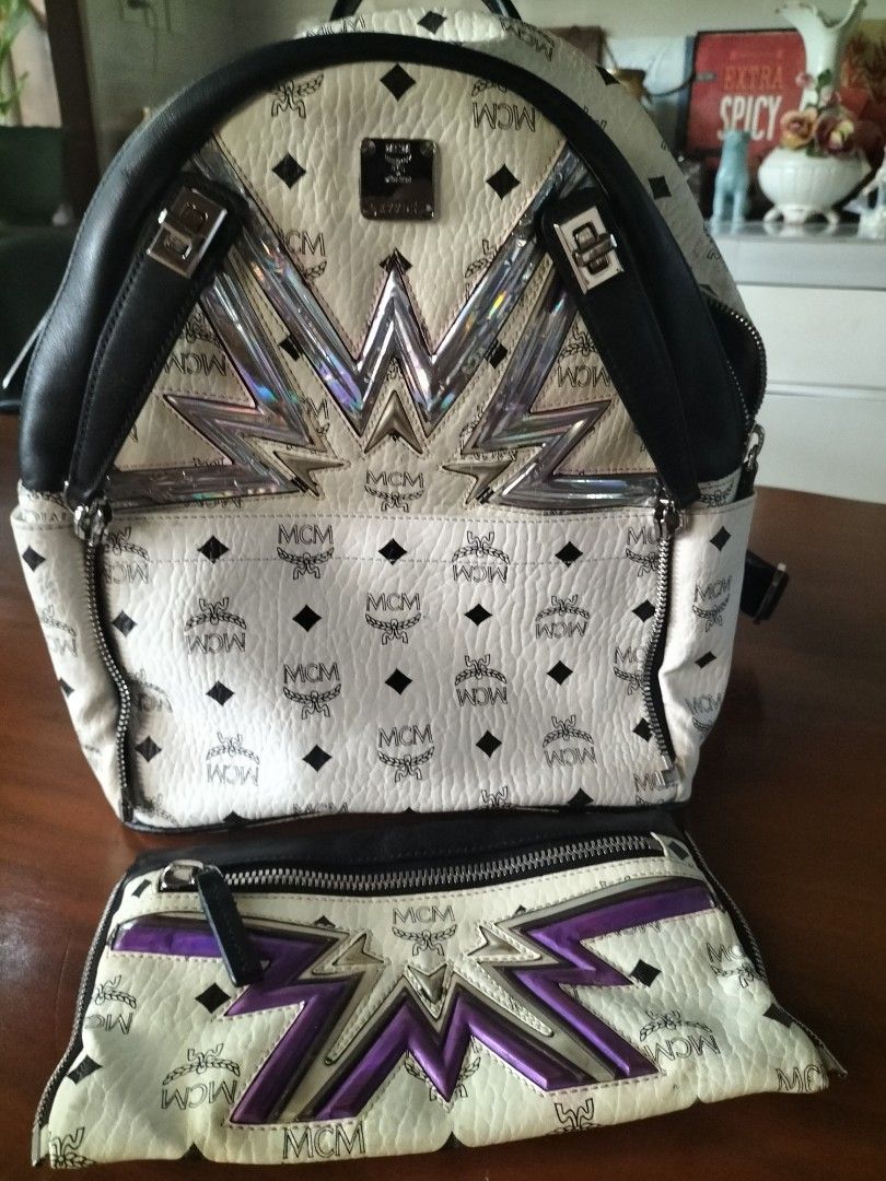 MCM Stark Backpack with Pouch (Category: Backpacks) located in Manila. Submitted by patriciab12636 (Listing ID 1464009756, Image 2). Description: - Authentic MCM backpack in white with signature monogram print. - Accented with black leather trim. - Includes a matching pouch with a bold starburst design. - Features a convenient zipped front pocket. - Adjustable straps for comfortable wear. - Ideal for everyday use or travel..