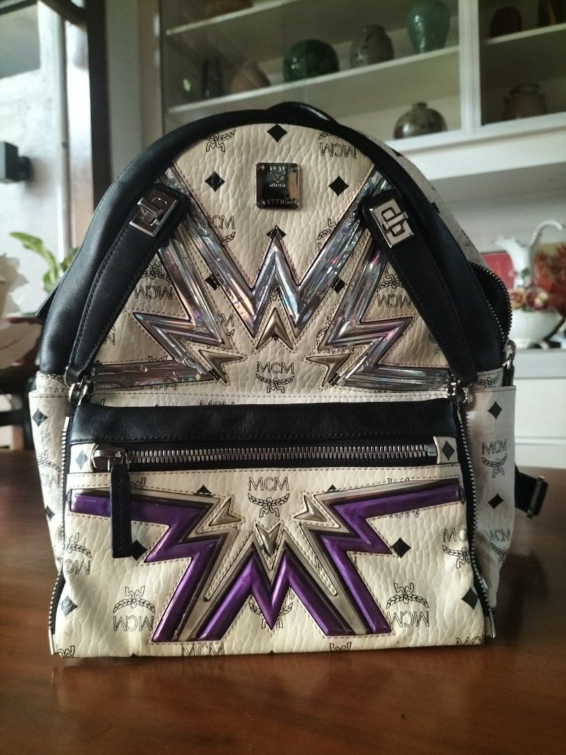 MCM Stark Backpack with Pouch (Category: Backpacks) located in Manila. Submitted by patriciab12636 (Listing ID 1464009756, Image 1). Description: - Authentic MCM backpack in white with signature monogram print. - Accented with black leather trim. - Includes a matching pouch with a bold starburst design. - Features a convenient zipped front pocket. - Adjustable straps for comfortable wear. - Ideal for everyday use or travel..