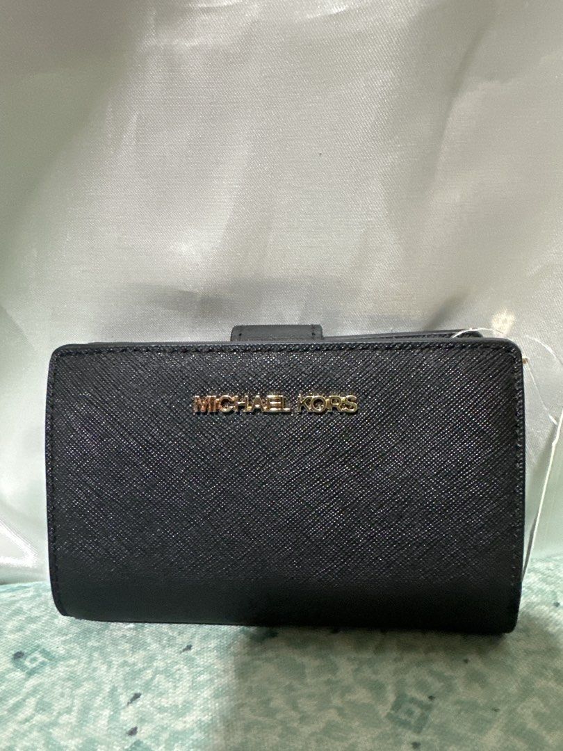 Michael Kors Black Saffiano Leather Wallet (Category: Wallets & Card holders) located in Balanga. Submitted by jk2025. (Listing ID 1463962671, Image 1). Description: - Authentic Michael Kors wallet - Color: Black - Material: Saffiano Leather - Hardware: Gold tone logo - Design: Compact bifold - Features: Ample card slots, coin pocket - Ideal for: Everyday use and stylish organization.
