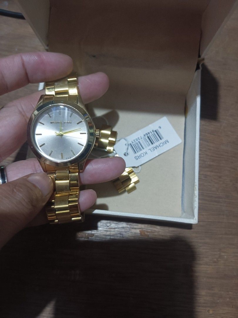 Michael Kors Gold Watch (Category: Women's Watches) located in Manila. Submitted by lhie20 (Listing ID 1463965330, Image 1). Description: - Authentic Michael Kors watch in gold. - Comes with original box and tag. - Features a simple and classic design. - Ideal for both everyday wear and special occasions. - Selling as it's not frequently worn..