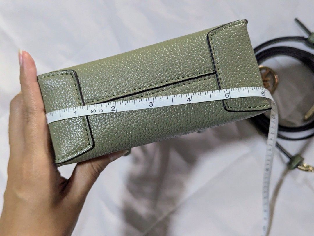 Michael Kors Green Leather Mini Tote Bag (Category: Luxury Bags & Wallets) located in Quezon City. Submitted by kuripotnya (Listing ID 1464059936, Image 2). Description: - Authentic Michael Kors mini tote bag - Color: Green - Material: Pebbled leather - Hardware: Gold details -preloved excellent condition 10/10 - Includes: Detachable crossbody strap - Interior: MK logo lining - Dimensions: Approx. 6" W x 7" H - Ideal for carrying essentials.