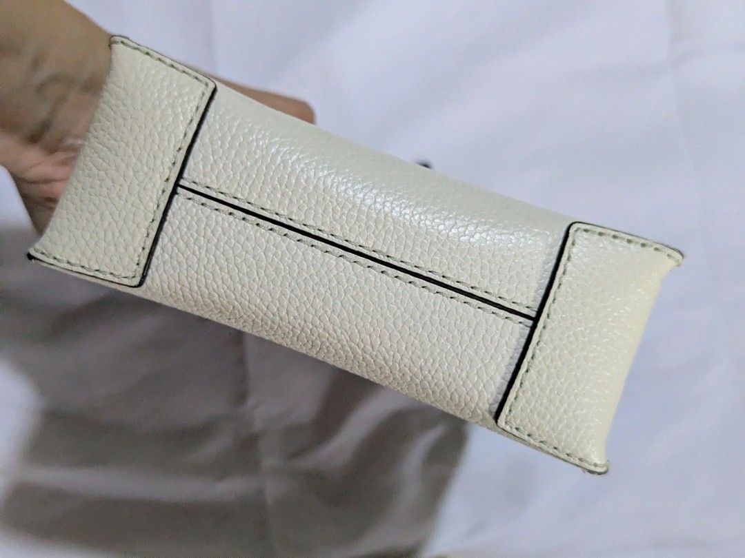 Michael Kors mercer white xs (Category: Luxury Bags & Wallets) located in Quezon City. Submitted by kuripotnya (Listing ID 1464058613, Image 3). Description: - Authentic Michael Kors white pebbled leather tote bag - Features elegant gold hardware details - Comes with a convenient detachable crossbody strap - Interior includes practical card slots - Versatile for everyday errands or a stylish night out - Measurements available in photos - preloved
