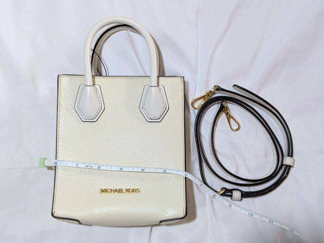 Michael Kors mercer white xs (Category: Luxury Bags & Wallets) located in Quezon City. Submitted by kuripotnya (Listing ID 1464058613, Image 1). Description: - Authentic Michael Kors white pebbled leather tote bag - Features elegant gold hardware details - Comes with a convenient detachable crossbody strap - Interior includes practical card slots - Versatile for everyday errands or a stylish night out - Measurements available in photos - preloved