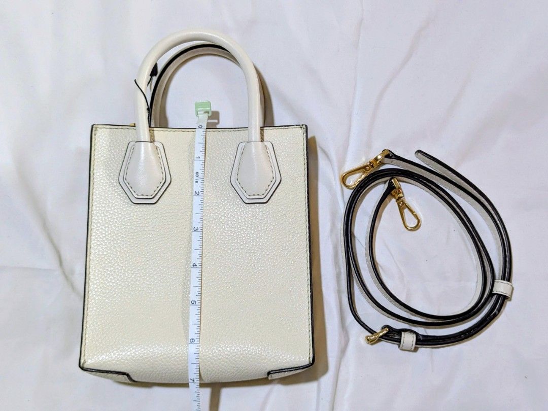 Michael Kors mercer white xs (Category: Luxury Bags & Wallets) located in Quezon City. Submitted by kuripotnya (Listing ID 1464058613, Image 2). Description: - Authentic Michael Kors white pebbled leather tote bag - Features elegant gold hardware details - Comes with a convenient detachable crossbody strap - Interior includes practical card slots - Versatile for everyday errands or a stylish night out - Measurements available in photos - preloved
