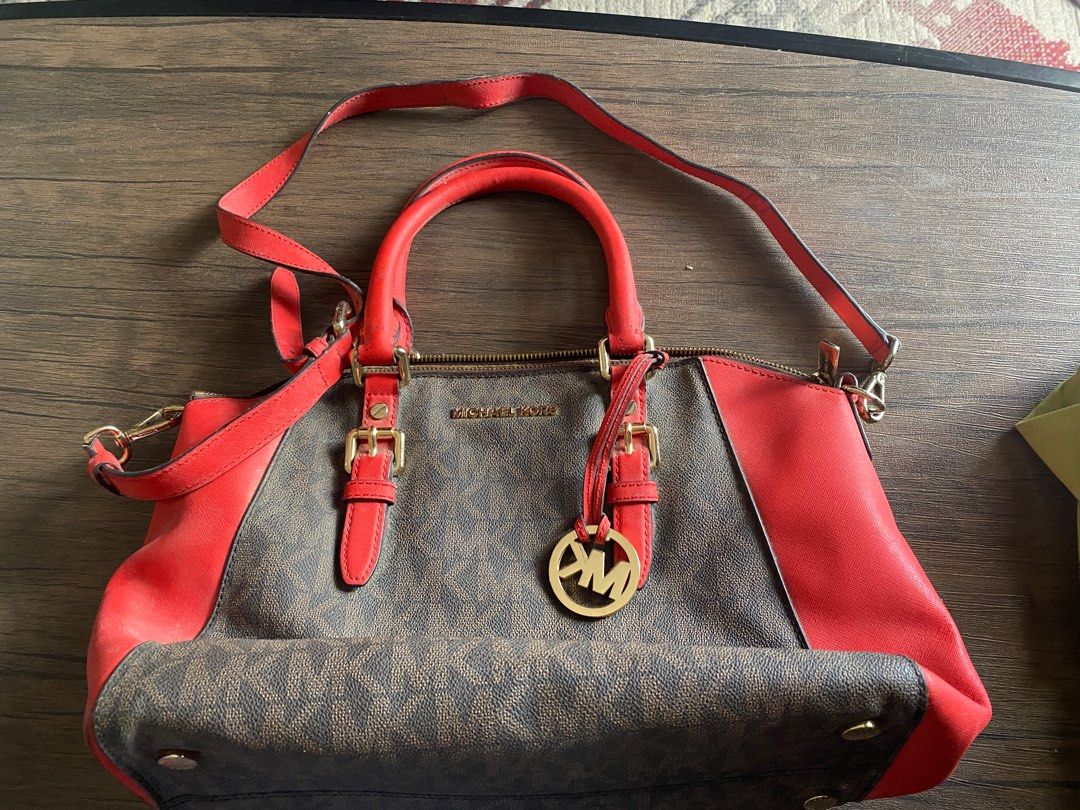 Michael Kors Monogram Canvas & Leather Satchel Handbag (Category: Luxury Bags & Wallets) located in Quezon City. Submitted by jiujitsu_la (Listing ID 1463964869, Image 1). Description: - Authentic Michael Kors satchel - Signature MK monogram canvas with red leather trim - Elegant gold hardware details - Versatile with top handles and detachable shoulder strap - Secure zipper closure - Shows some signs of wear on leather trim and strap.