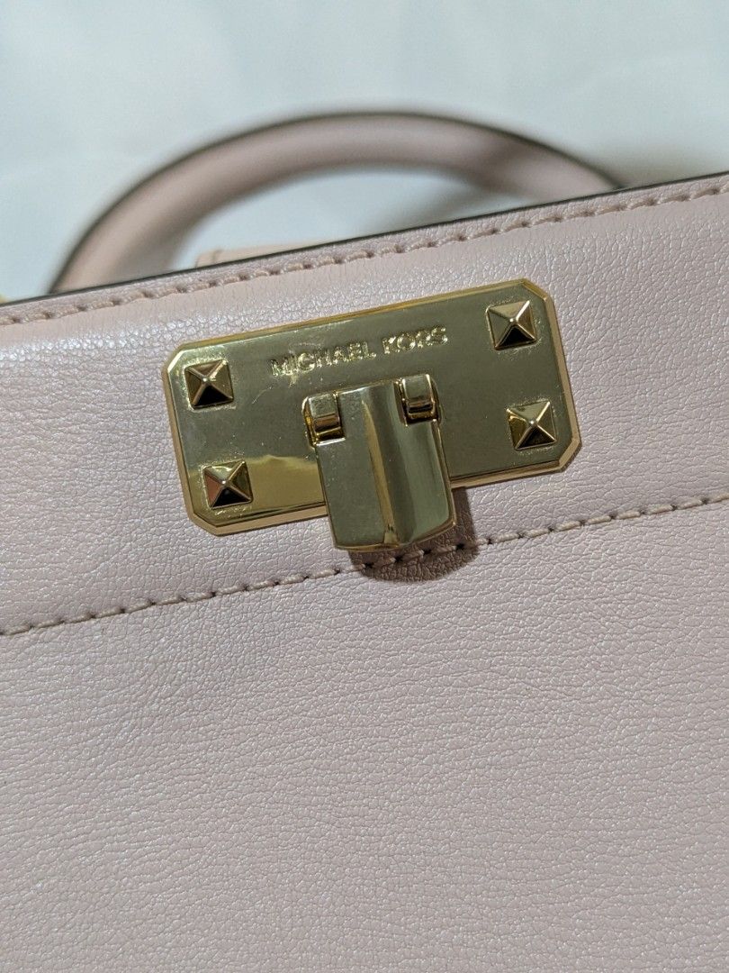 Michael Kors Pink Leather Top Handle Bag (Category: Luxury Bags & Wallets) located in Quezon City. Submitted by kuripotnya (Listing ID 1464062130, Image 2). Description: - Authentic Michael Kors handbag - Beautiful light pink color - Elegant gold hardware accents - Comfortable top handles - includes shoulder/crossbody strap - Secure clasp closure for your belongings - Spacious interior with multiple compartments - Compact size, approximately 10 i