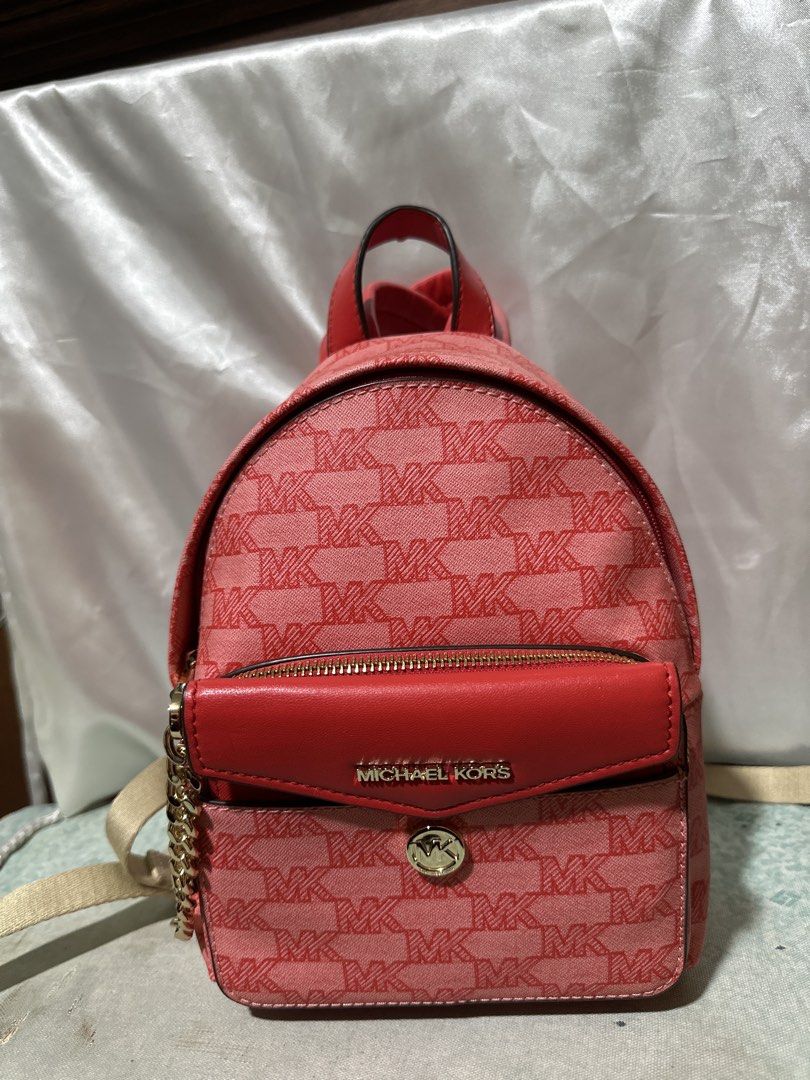 Michael Kors Pink MK Signature Backpack (Category: Backpacks) located in Balanga. Submitted by jk2025. (Listing ID 1463953376, Image 1). Description: - Adorable pink Michael Kors backpack - Signature MK pattern all over - Convenient front zip pocket - Stylish smaller flap pocket with Michael Kors logo - Chic gold chain detail on the side - Versatile for everyday wear or evening outings.