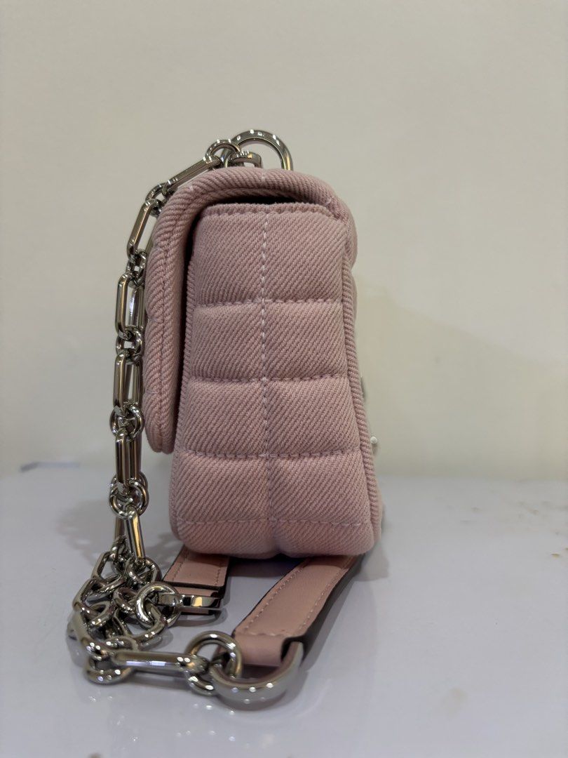 Michael Kors Pink Quilted Denim Shoulder Bag (Category: Luxury Bags & Wallets) located in Malabon City. Submitted by everythingpreloveddd (Listing ID 1464024596, Image 3). Description: - Pink quilted denim shoulder bag - Brand: Michael Kors - Silver chain strap and hardware - Secure turn-lock closure - Compact size: 12cm across the front - Versatile for everyday or evening wear.