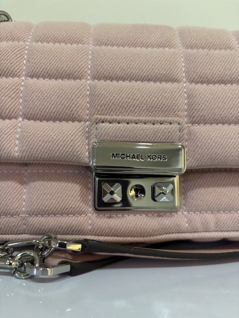 Michael Kors Pink Quilted Denim Shoulder Bag (Category: Luxury Bags & Wallets) located in Malabon City. Submitted by everythingpreloveddd (Listing ID 1464024596, Image 2). Description: - Pink quilted denim shoulder bag - Brand: Michael Kors - Silver chain strap and hardware - Secure turn-lock closure - Compact size: 12cm across the front - Versatile for everyday or evening wear.