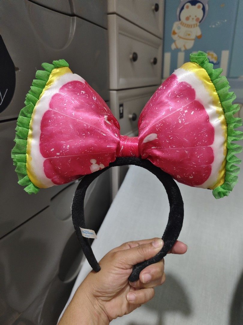 Minnie Mouse Watermelon Bow Headband (Category: Hair Accessories) located in Makati City. Submitted by abegailbrezuela (Listing ID 1463980667, Image 2). Description: - Adorable Minnie Mouse Watermelon slice design bow headband. - Features a satin bow with realistic black seeds. - Green ruffled edges add a playful touch. - Comfortable black fuzzy headband. - Ideal for parties, casual wear, and summer vibes..