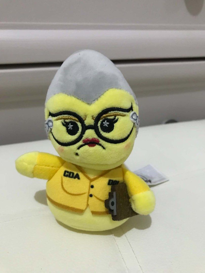 Monsters Inc- Roz wishables (Category: Plushies & Soft Toys) located in Manila. Submitted by hearthearty (Listing ID 1464046550, Image 1). Description: - Adorable yellow plush toy - Features grey hair and glasses - Wears a yellow vest with 'CDA' and 'DOI' patches - Holding a small brown clipboard - Ideal for display or play - Fun collectible item.