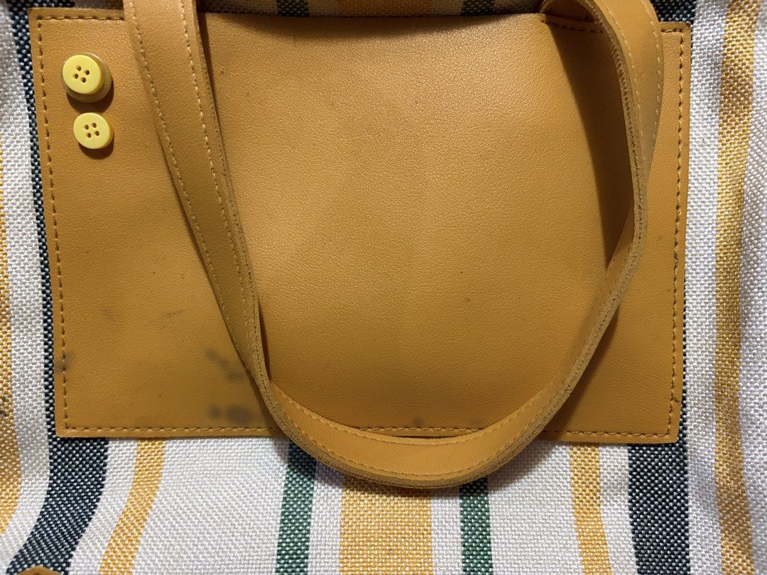 Mustard Striped Canvas Tote/Shoulder Bag (Category: Luxury Bags & Wallets) located in Muntinlupa City. Submitted by herellas0504 (Listing ID 1464083179, Image 3). Description: Mustard Striped Canvas Tote/Shoulder Bag Mine: 100 | Lock: 170 ———————————— perfect for school & casual outings spacious, can put notebooks, iPad, phone, aniks, etc issue: see slides (w/small stain front outside & need see inside pocket, broken zipper but still working just