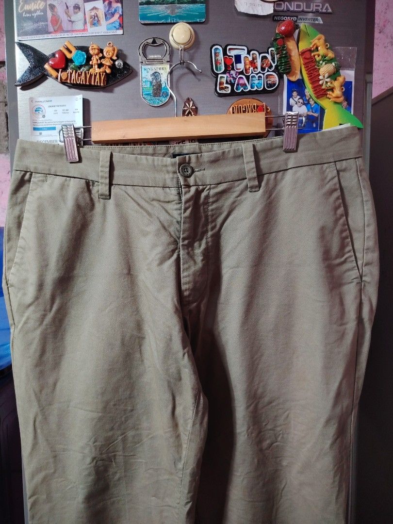 Nautica Khaki Chino Pants (Category: Chinos) located in General Santos City (Dadiangas). Submitted by rafaelmir09800 (Listing ID 1463965151, Image 2). Description: - Brand: Nautica - Color: Khaki - Size 34 on tag, fits 33-35 - Fit: Classic Straight Leg - Closure: Button and zip front - Pockets: Two back pockets with button closure - Style: Versatile for casual or smart casual wear.