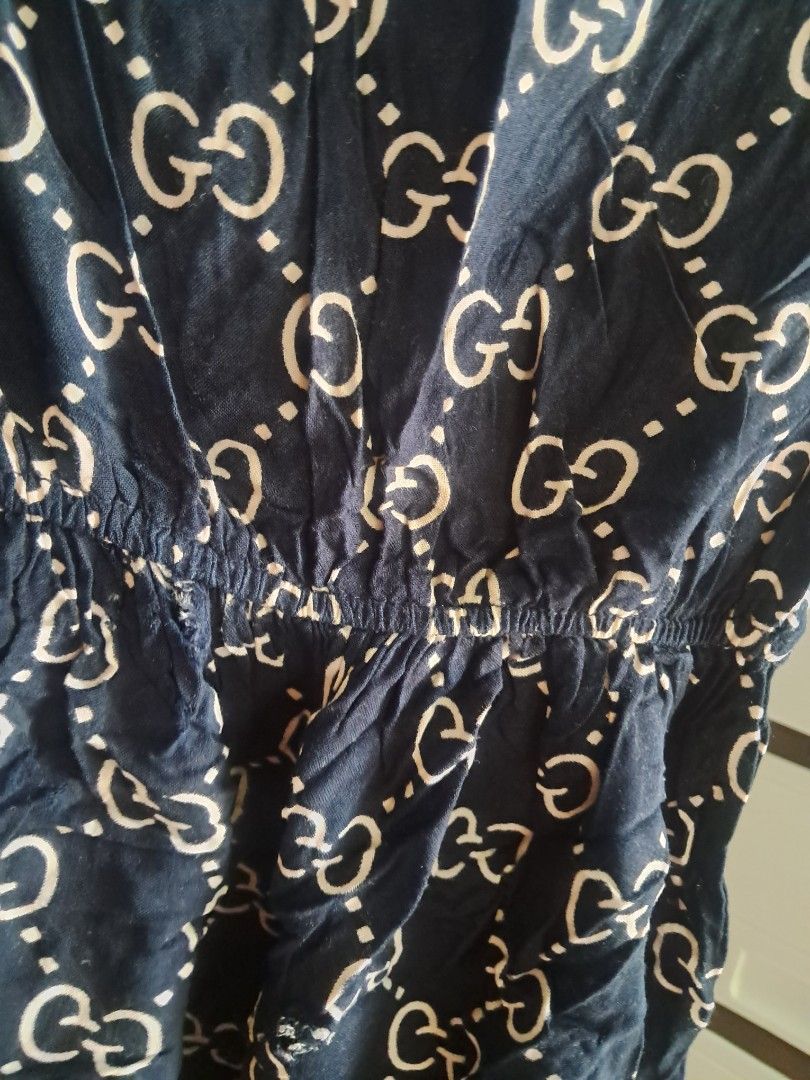 Navy Blue Gucci Monogram Dress (Category: Babies & Kids Fashion) located in Real. Submitted by marcomarjo53691 (Listing ID 1464051974, Image 2). Description: - Navy blue dress with iconic all-over white Gucci monogram print. - Comfortable elasticated waist for a flattering fit. - Short sleeves for a relaxed feel. - Ideal for everyday casual wear..