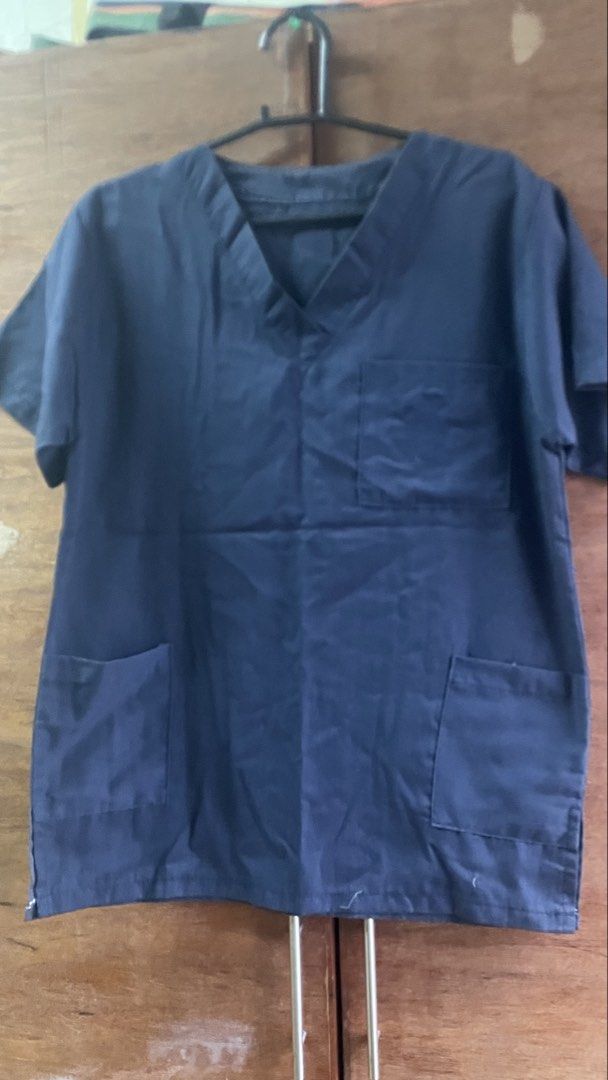 Navy Blue Scrub Top and Pants Set (Category: Sets or Coordinates) located in Manila. Submitted by carolinest97765 (Listing ID 1464044265, Image 1). Description: - Navy blue V-neck scrub top with pockets - Matching scrub pants with elastic waist and drawstring - Comfortable and practical for work - Durable and easy to move in - Ideal for medical professionals and workwear needs.