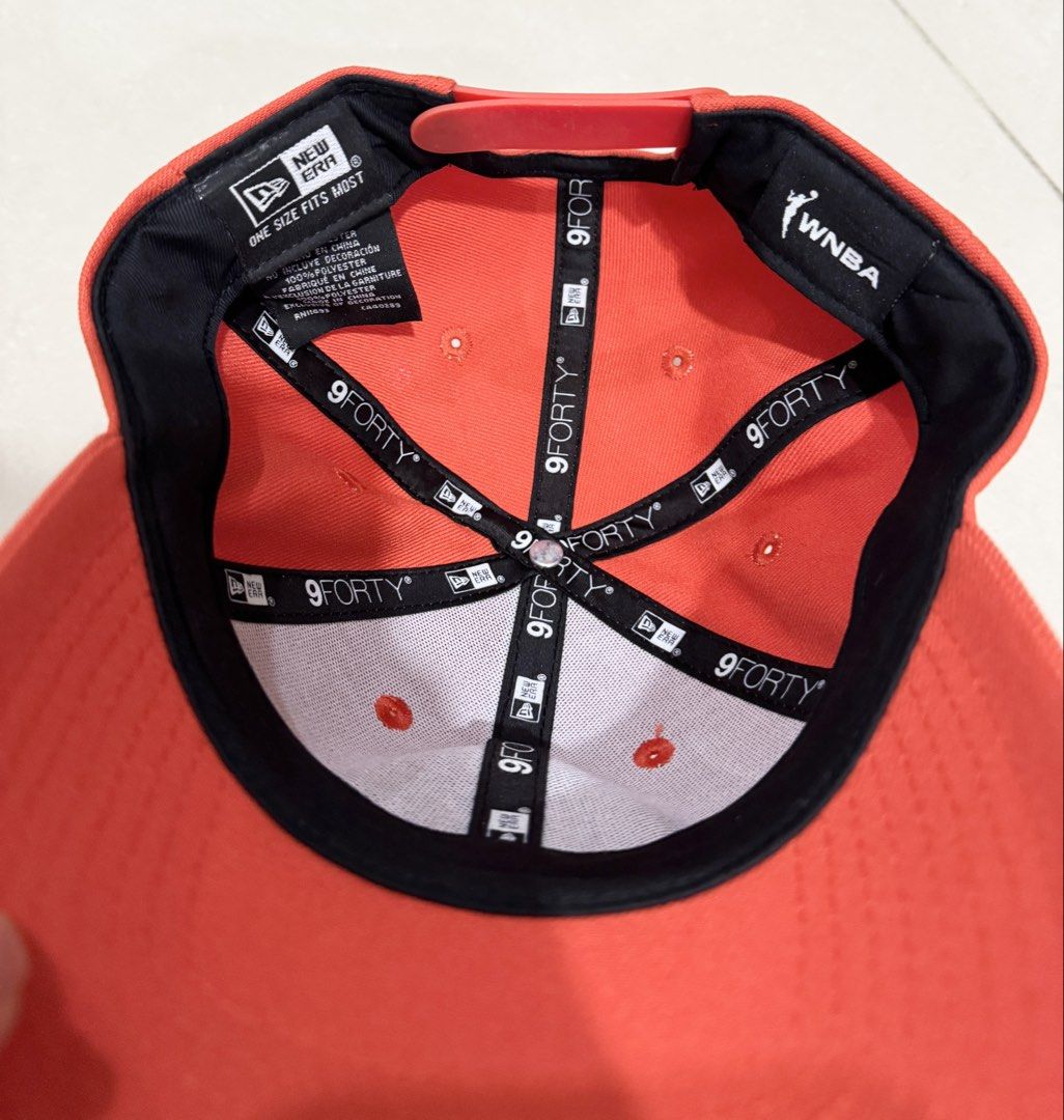 New Era WNBA Orange Snapback Cap (Category: Caps & Hats) located in Pasay City. Submitted by prelovedd.nutz (Listing ID 1464117500, Image 2). Description: - Orange New Era 9FORTY cap - Features the WNBA logo on the side - Adjustable snapback for a comfortable, one-size-fits-most fit - Clearly displays the team logo on the front - Ideal for any basketball fan Meet up Available 😊 Grab delivery Available- Buyer covered the delivery fee..