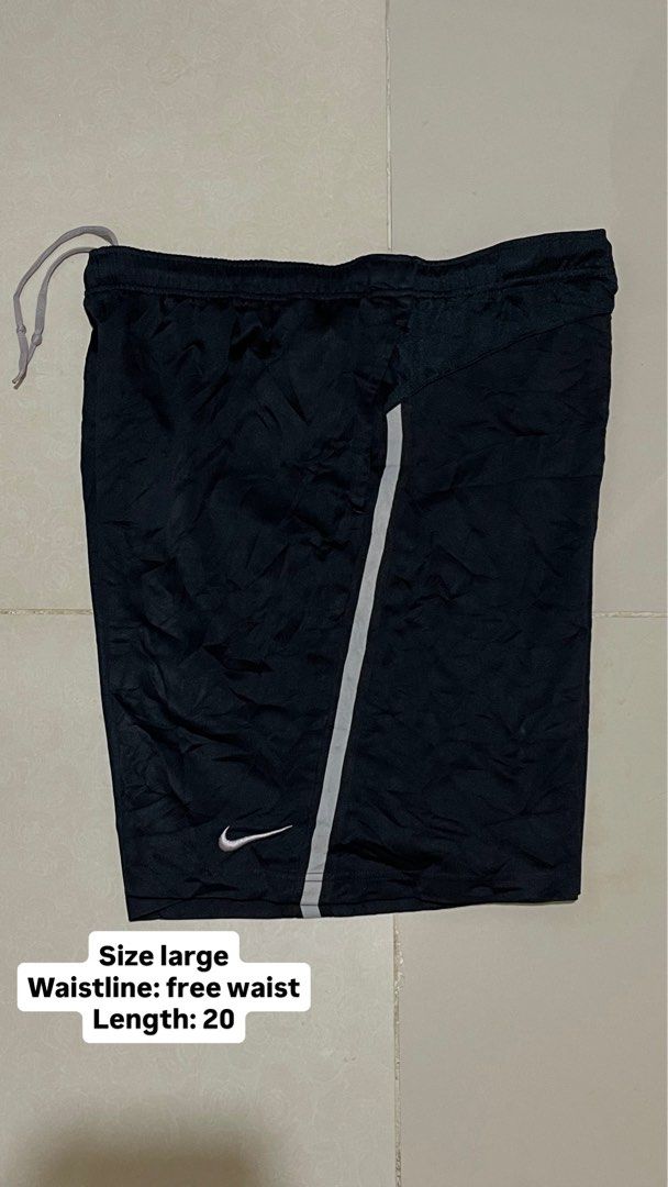 Nike Black Athletic Shorts Size Large (Category: Shorts) located in Manila. Submitted by micoletszx81430 (Listing ID 1464073012, Image 2). Description: - Black Nike athletic shorts - Size Large - Free waist - 20 inches length - Features drawstring - Side stripe detail - Visible Nike logo on front - Ideal for sports or casual wear.