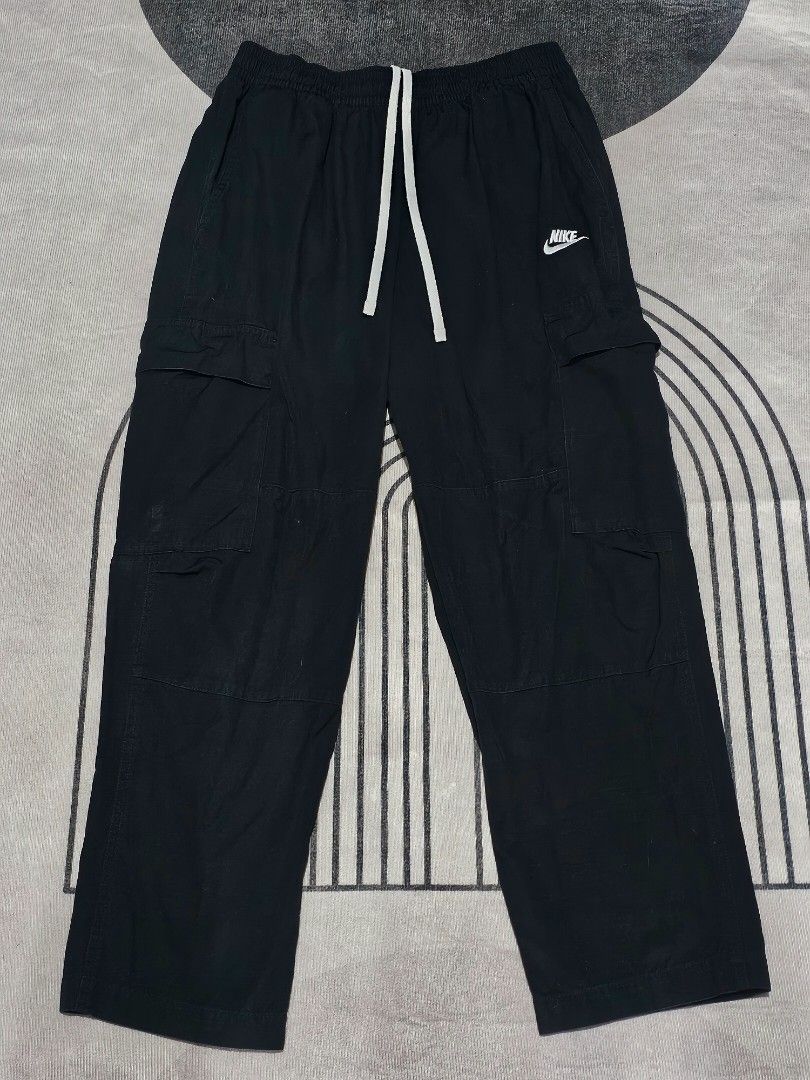 Nike black Cargo (Category: Joggers) located in Baguio. Submitted by kayeonlineshop (Listing ID 1464031580, Image 2). Description: Nike Sportswear Club Men's Woven Cargo Pants in black, featuring a contrast white drawstring and utility cargo pockets w28-36 l36.5 h8.