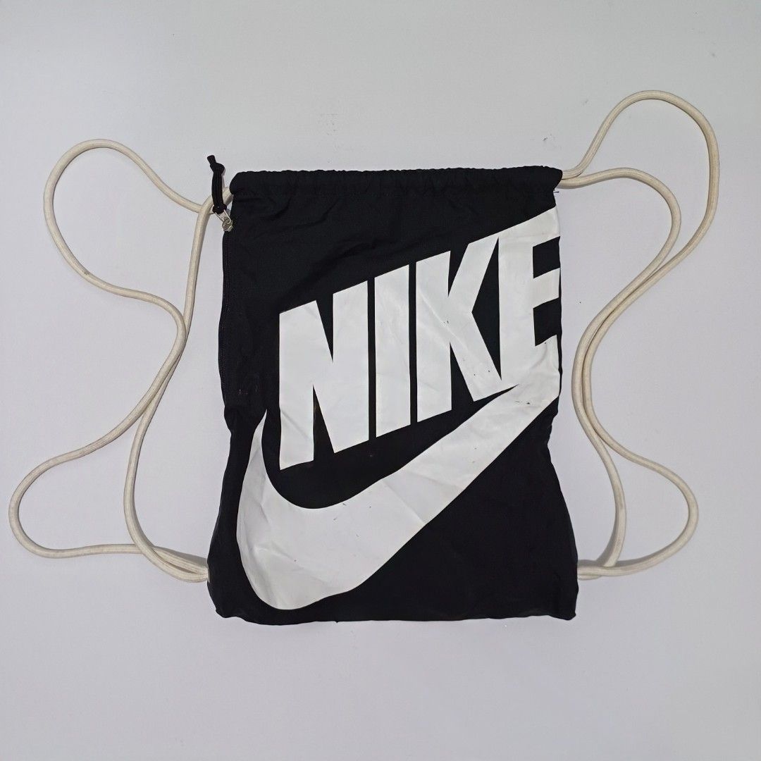 Nike Black Drawstring Bag (Category: Backpacks) located in Pasig City. Submitted by padillaaub64242 (Listing ID 1463993352, Image 1). Description: - Black Nike drawstring bag - Large white Nike logo.