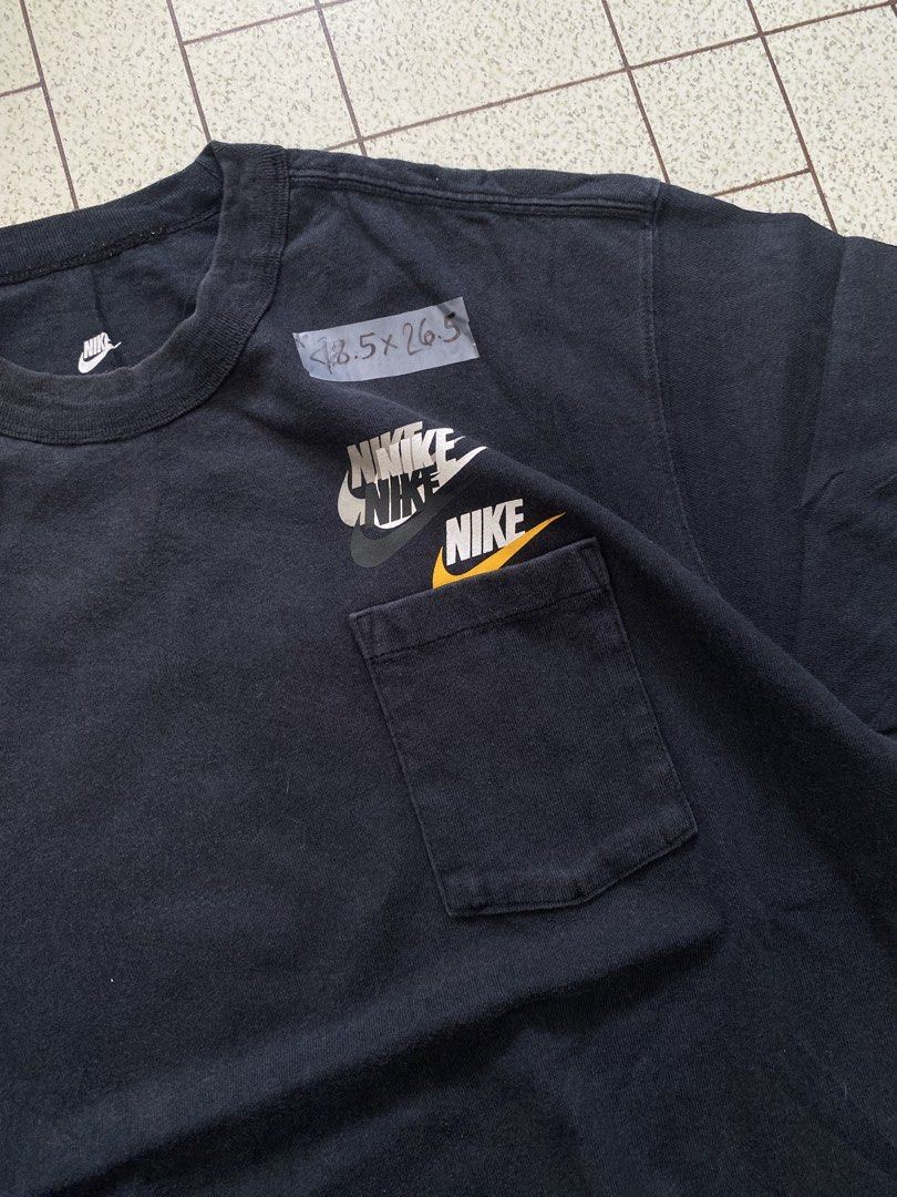Nike Black Pocket Tee "The Nike Tee" (Category: Tshirts & Polo Shirts ) located in Manila. Submitted by sepamorash53558 (Listing ID 1464051687, Image 2). Description: - Black Nike T-shirt - Features a chest pocket - Multiple Nike logos on chest - 100% Cotton - Size S - Ideal for casual wear.