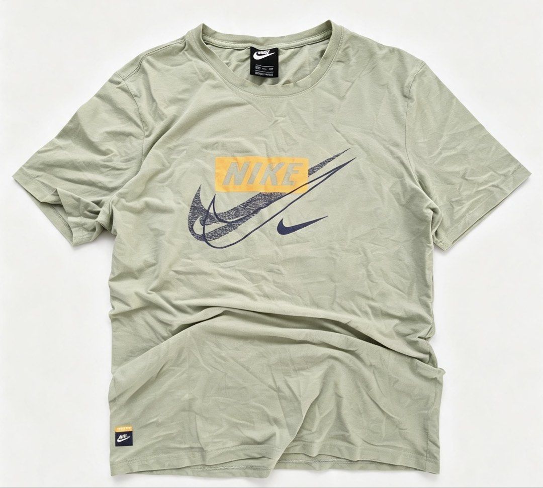 NIKE Box Logo Tee Sage Green 2XL (Category: Tshirts & Polo Shirts ) located in Manila. Submitted by jayve_montecillo (Listing ID 1463997994, Image 1). Description: NIKE Big Swoosh Graphic Tee Sage Green • Brand: NIKE - Authentic with neck tag + hem tag • Size: 2XL on tag | Dimes: W20 x L27 | Chest 40” • Color: Sage Green with Orange Box + Navy Swoosh • Condition: 7.5/10 - May 2-3 small dots/stains sa harap see last pics. Print goods pa, no cracks