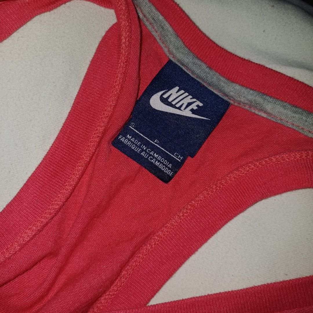 Nike Coral Racerback Tank Top (Category: Activewear) located in Pasig City. Submitted by padillaaub64242 (Listing ID 1463995370, Image 2). Description: - Coral pink Nike tank top - Large light blue Nike swoosh logo on front - Racerback style - Made in Cambodia - Size S -17×25 inches.
