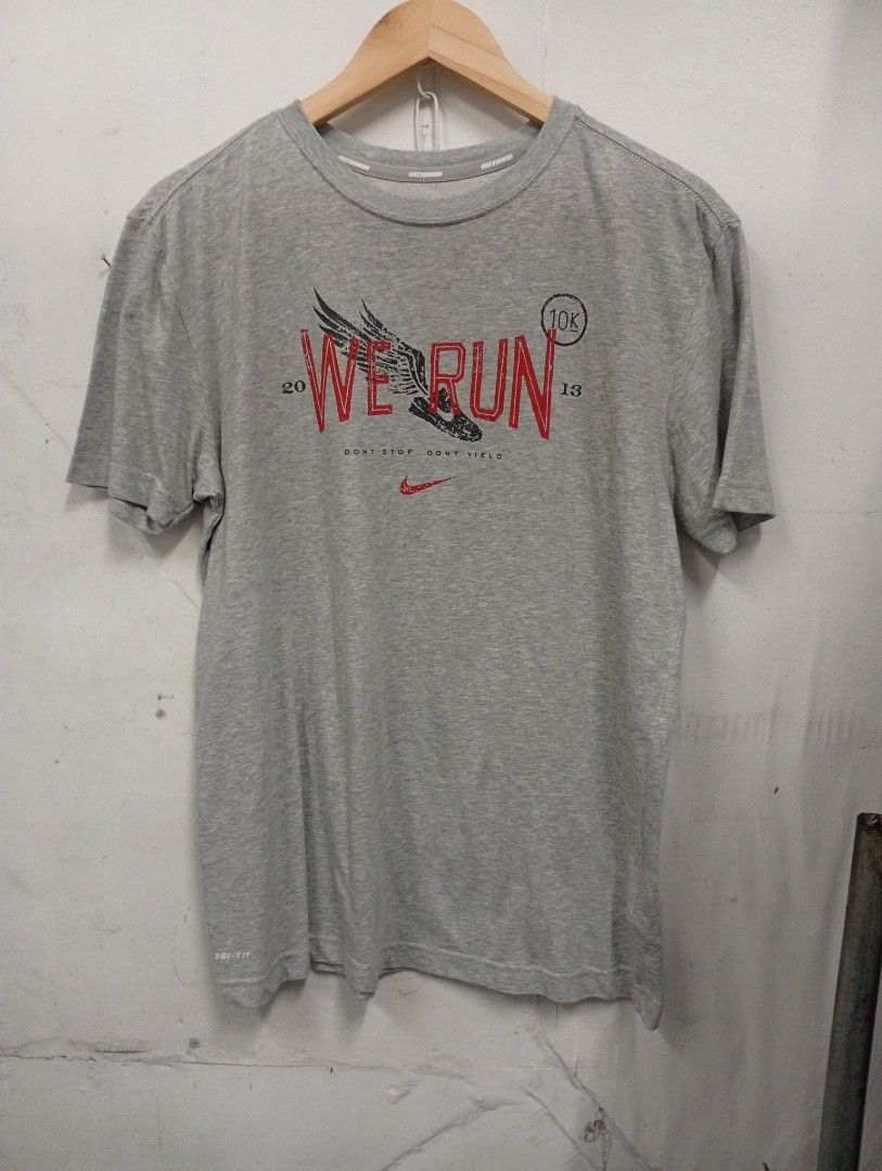 Nike Dri-Fit Running T-Shirt (Category: Activewear) located in Manila. Submitted by annemanzano120906 (Listing ID 1463946129, Image 1). Description: - Grey Nike Dri-Fit T-shirt - Size: Large (L) - 'We Run 10K 2013' graphic on front - Nike Running printed on collar - Ideal for running or casual wear.
