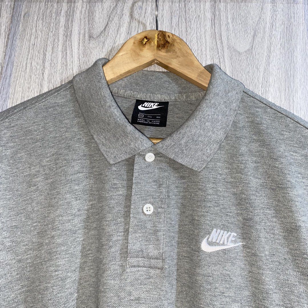 Nike Grey Polo Shirt (Category: Tshirts & Polo Shirts ) located in Manila. Submitted by _thriftanddrip (Listing ID 1464092233, Image 3). Description: 24 x 29 (X-large) Like new ₱600 plus shipping fee Grey Nike polo shirt. Short sleeves with a classic collar and button placket. Features the iconic Nike swoosh logo embroidered on the chest. Made in Indonesia. Great for casual wear or a sporty look..