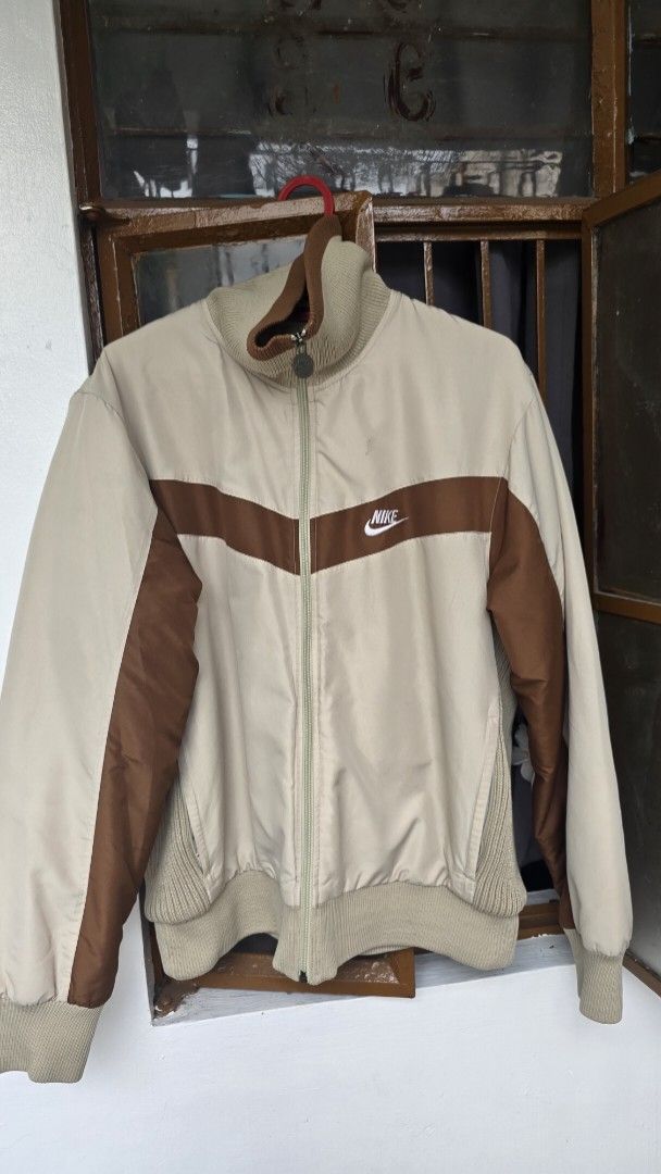 Nike Track Jacket Beige Brown Size L (Category: Coats, Jackets and Outerwear) located in Taguig. Submitted by d.ballete (Listing ID 1464084980, Image 1). Description: Kaya ng Medium - Large Thick yung material May konting stain lang based sa picture, pero di ganon kavisible With wash tag, and working ang zipper Negotiable basta madami kukunin.