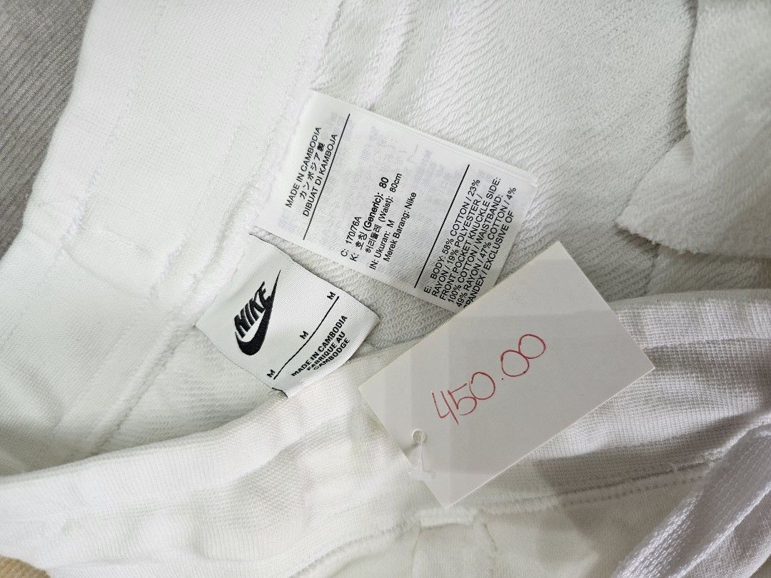 Nike White Shorts (Category: Shorts) located in Baguio. Submitted by kayeonlineshop (Listing ID 1463996472, Image 2). Description: white Nike Club French Terry Shorts featuring a raw-edge hem and a small black embroidered logo on the leg w 29- 32 l19.5 h14 inches.