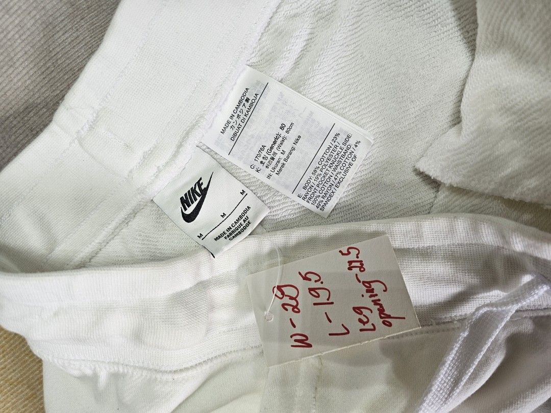 Nike White Shorts (Category: Shorts) located in Baguio. Submitted by kayeonlineshop (Listing ID 1463996472, Image 3). Description: white Nike Club French Terry Shorts featuring a raw-edge hem and a small black embroidered logo on the leg w 29- 32 l19.5 h14 inches.