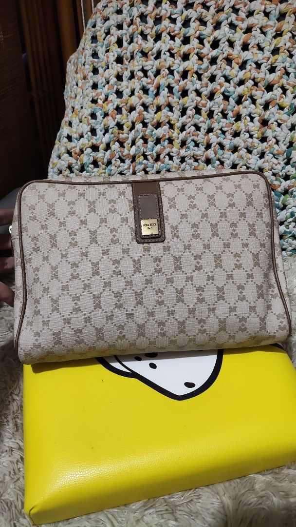 Nina Ricci (Category: Clutches) located in Cebu City. Submitted by lumaynojes00490 (Listing ID 1463964955, Image 3). Description: - Signature monogram pattern - Beige and brown colorway - Small leather tab detail on front - Ideal for organizing essentials or as a clutch - Zipper closure.