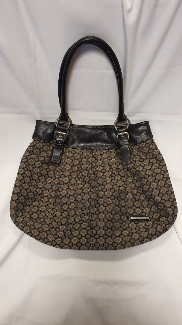 Nine West Monogrammed Shoulder Bag (Category: Shoulder Bags) located in Pasig City. Submitted by angel025 (Listing ID 1464125985, Image 1). Description: - Classic Nine West shoulder bag - Features iconic monogram pattern - Stylish black leather trim and handles - Secure zipper closure - Interior zip pocket and slip pockets for organization - Spacious enough for everyday essentials - A versatile and practical choice for daily use.