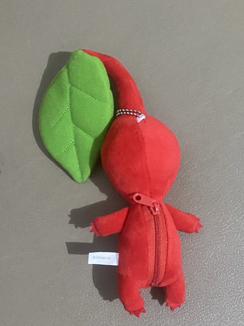 Nintendo Pikmin Red Plush Toy (Category: Plushies & Soft Toys) located in Davao. Submitted by hoowans_surplus (Listing ID 1464067686, Image 2). Description: - Adorable red Pikmin plush toy - Features a convenient zipper on the back - Compact and portable size - Ideal for any Pikmin enthusiast - Makes a great collectible or gift.