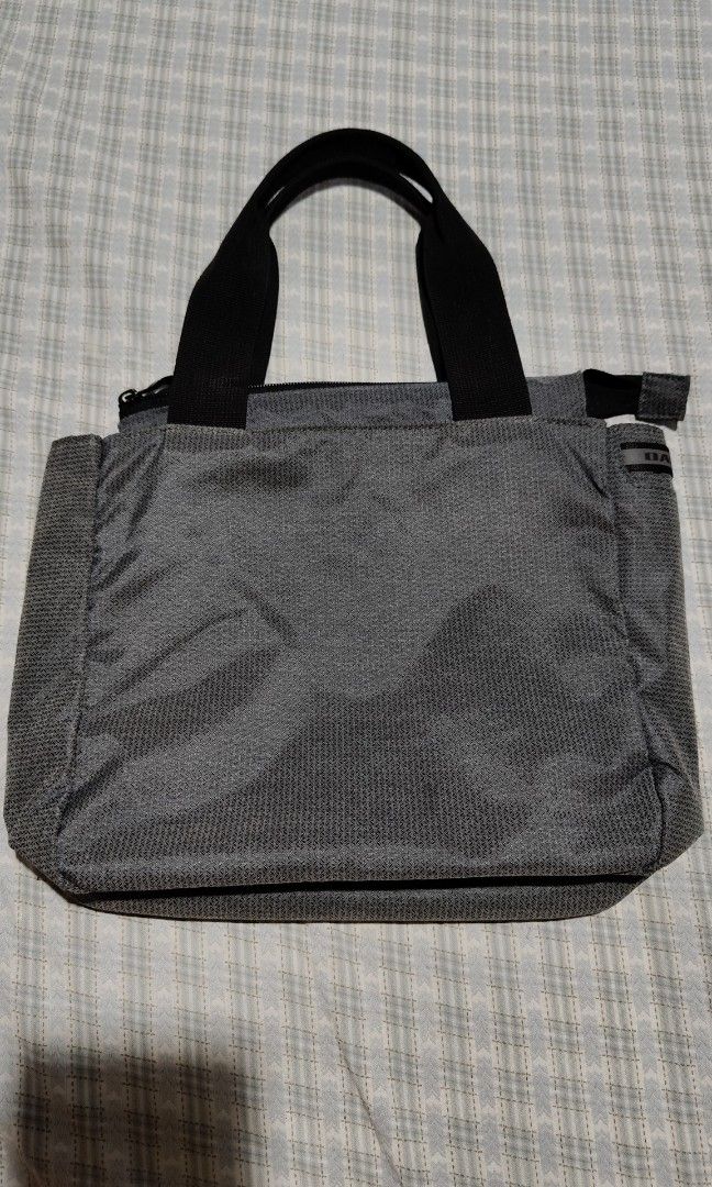 Oakley Essential Small Tote Bag (Category: Tote Bags) located in Davao. Submitted by kib_abagnalejr. (Listing ID 1464049332, Image 2). Description: Oakley Essential Small Tote featuring a distinctive diagonal front zipper and black top handles - In Pristine Condition.