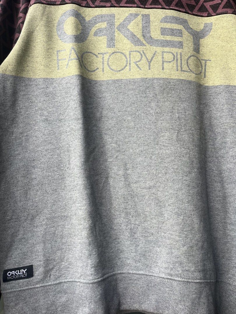 Oakley Factory Pilot Crewneck Sweatshirt (Category: Coats, Jackets and Outerwear) located in Manila. Submitted by kingjamessthriftt (Listing ID 1464005363, Image 2). Description: - Oakley Factory Pilot Sweatshirt - Crewneck, long sleeves - Grey main body with yellow chest stripe - Geometric pattern on upper part and sleeves - Size: Medium (M) - Made in China.