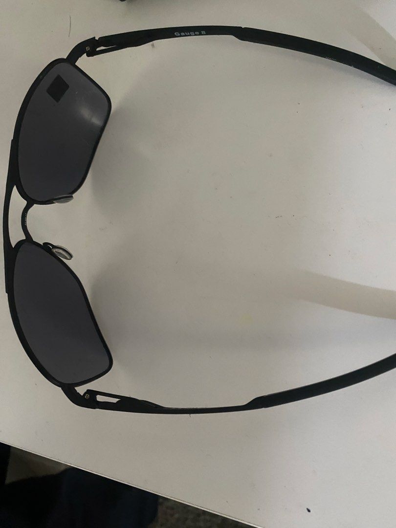 Oakley Gauge 8 Sunglasses (Category: Sunglasses & Eyewear) located in Mandaluyong City. Submitted by janleevee (Listing ID 1463956624, Image 2). Description: - Oakley Gauge 8 Sunglasses - Color: Black frame with dark lenses - Material: Lightweight metal frame - Versatile: Suitable for sports or everyday wear - Condition: Minor signs of use on frame, lenses are clear - Sale terms: Selling as is.