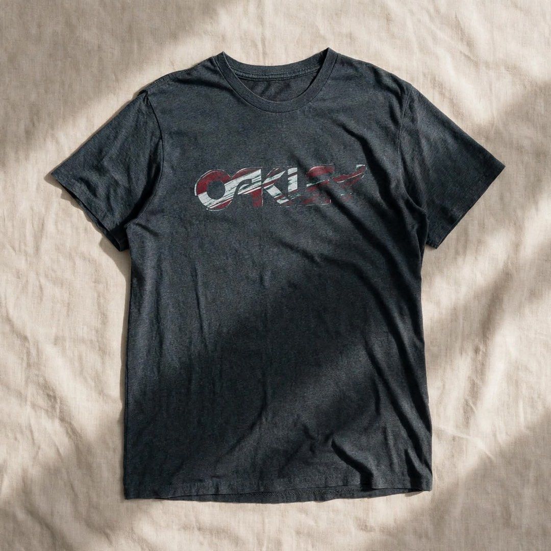 Oakley tshirt (Category: Luxury Apparel) located in Digos. Submitted by thriftnigoy (Listing ID 1463999438, Image 1). Description: OAKLEY PM📥 Dimes: inches Width 20 length:28 Best fit medium - Excellent condition - color rate 10 - no issue.