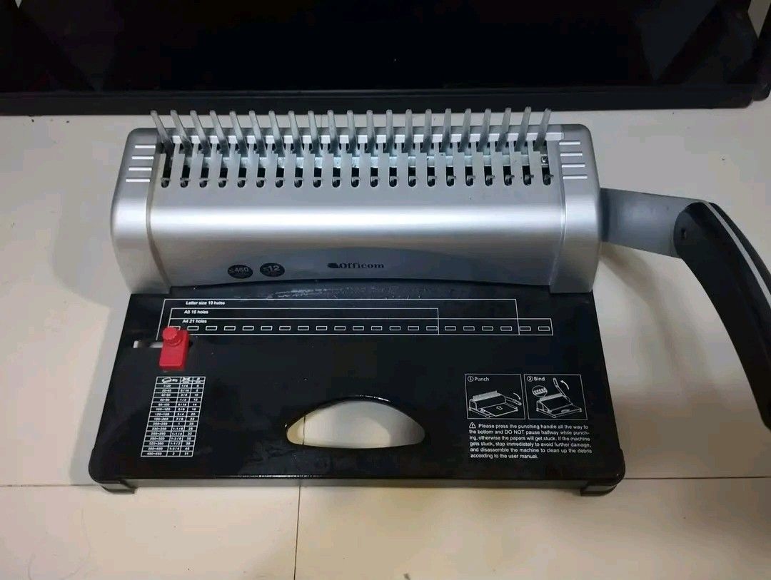 Officom 12-Sheet Comb Binding Machine (Category: Office & Business Technology) located in Marilao. Submitted by zettevibar (Listing ID 1464056935, Image 1). Description: - Officom Comb Binding Machine - Punches up to 12 sheets at once - Compatible with Letter, A5, and A4 paper sizes - Features a handle for effortless punching and binding - User instructions conveniently printed on the base - Ideal for organizing your important documents.
