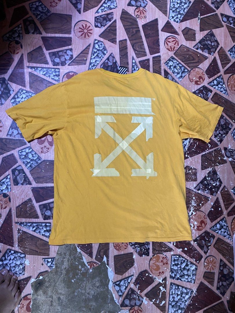 Off-White Yellow Graphic T-Shirt (Category: Tshirts & Polo Shirts ) located in Manila. Submitted by kentmarion.water (Listing ID 1464042517, Image 2). Description: - Yellow Off-White t-shirt - Iconic Off-White arrows graphic on the back - Small logo on the front chest - Tag is visible - Minor creasing on the back graphic print (please check photos for details) - Ideal addition to any streetwear collection.