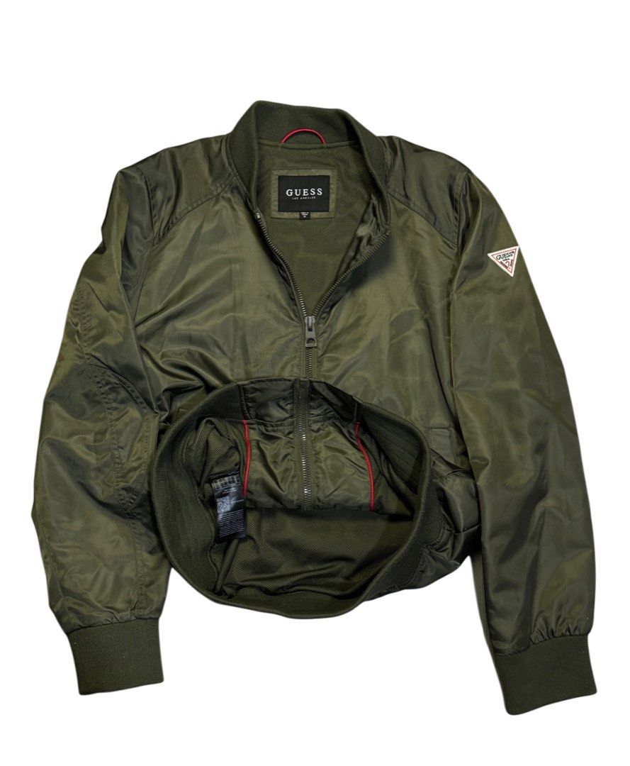 Olive Green GUESS Bomber Jacket (Category: Coats, Jackets and Outerwear) located in Caloocan City. Submitted by mzcollection_349 (Listing ID 1463961825, Image 2). Description: - Olive green GUESS bomber jacket - Classic MA-1 style - Zip-up front with two side pockets - Ribbed cuffs and hem for a snug fit - Vibrant red interior lining - Ideal for versatile layering.