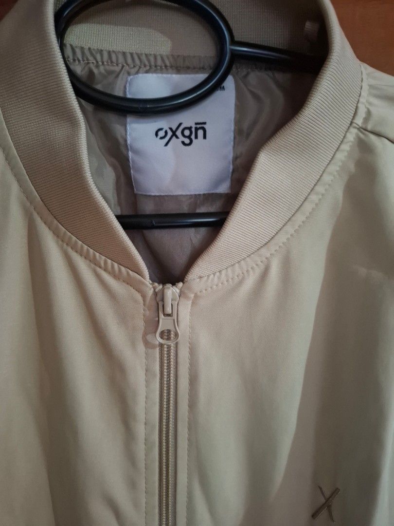 Oxgn Bomber Jacket Medium (Category: Coats, Jackets and Outerwear) located in Muntinlupa City. Submitted by googoosh_collection (Listing ID 1463998942, Image 3). Description: - Brand: Oxgn - Color: Khaki - Style: Bomber Jacket - Size: Medium - Features: Zip-up front, pockets - Detail: Small embroidered logo on chest - Occasion: Casual wear *RFS: Maliit sa akin di nagamit bagong bago pa) MOD: Lalamove/ Gogo express (Shipping fee shouldered by the 