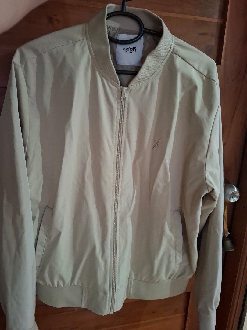 Oxgn Bomber Jacket Medium (Category: Coats, Jackets and Outerwear) located in Muntinlupa City. Submitted by googoosh_collection (Listing ID 1463998942, Image 2). Description: - Brand: Oxgn - Color: Khaki - Style: Bomber Jacket - Size: Medium - Features: Zip-up front, pockets - Detail: Small embroidered logo on chest - Occasion: Casual wear *RFS: Maliit sa akin di nagamit bagong bago pa) MOD: Lalamove/ Gogo express (Shipping fee shouldered by the 