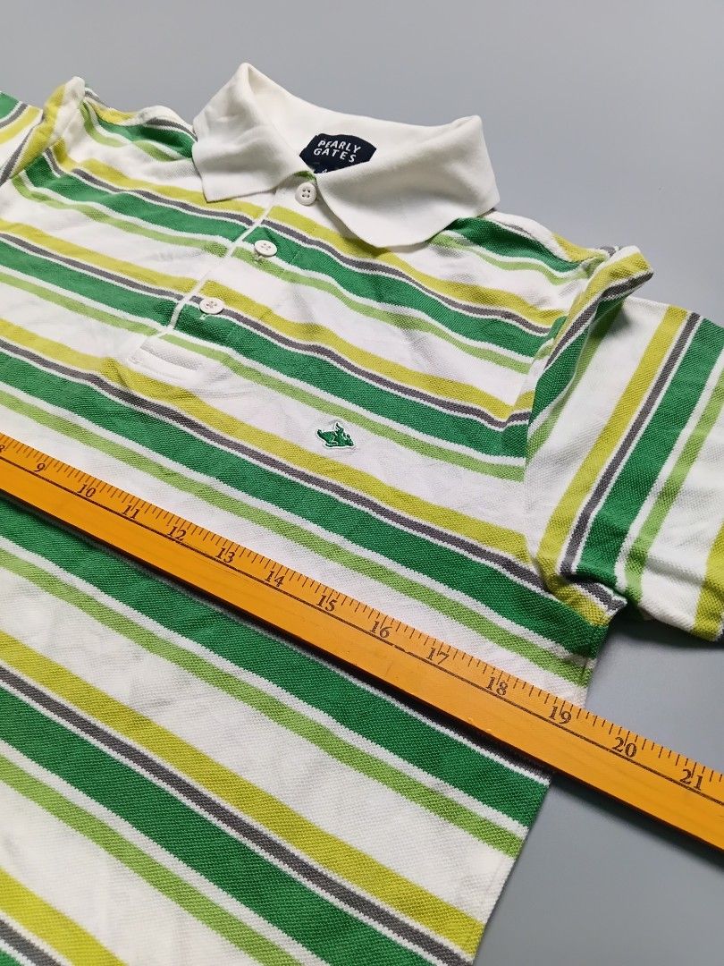 Pearly Gates. POLO SHIRT (Category: Tshirts & Polo Shirts ) located in Manila. Submitted by hustler_777 (Listing ID 1464034820, Image 3). Description: Key Features Observed:Brand Label: The inner neck tag explicitly reads "PEARLY GATES" with a size number 4 printed right below it.Signature Logo: On the lower right chest area, there is a small embroidered green rabbit flying motif, which is the iconic mascot of the brand.Design & Styling: Features