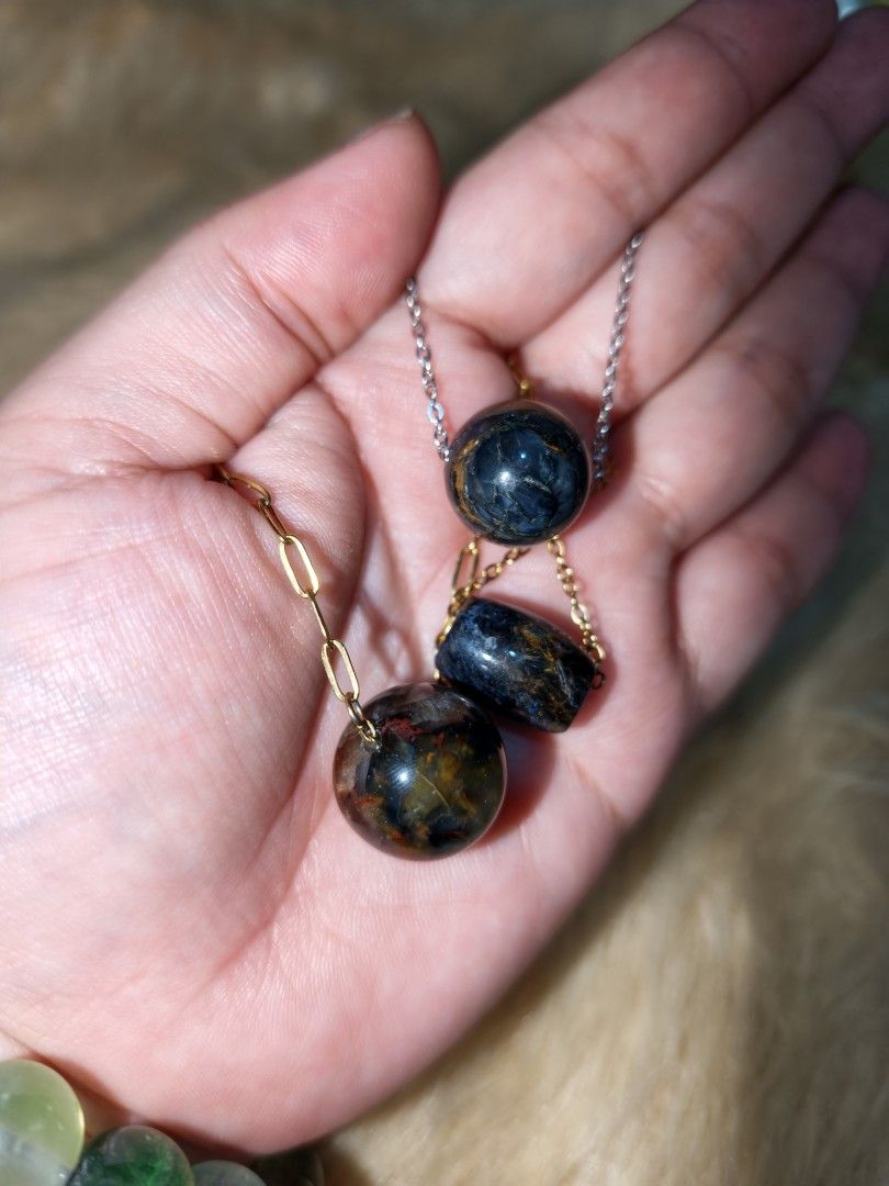 Pietersite Pendants Natural Crystal (Category: Necklaces) located in Quezon City. Submitted by piaoliangcollections.ph (Listing ID 1463950279, Image 2). Description: price is per piece. Natural Pietersite Crystal. Pietersite is known as the "Tempest Stone" because its swirling, storm-like patterns of gold, blue, bronze, and gray resemble a turbulent storm. Core Meanings & Metaphysical Properties Transformation & Change: Pietersite is viewed as a 